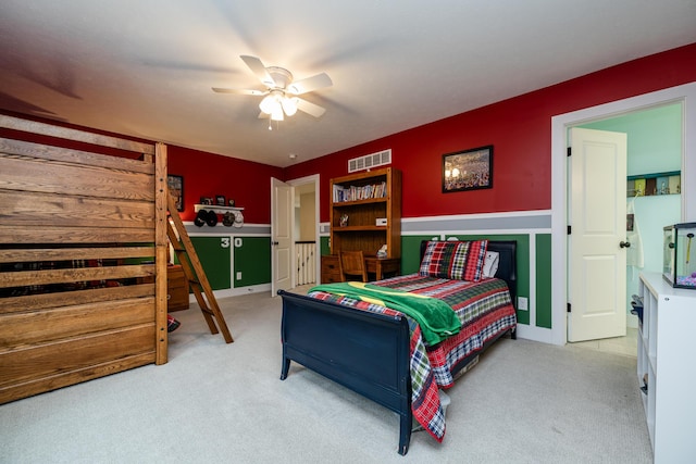 bedroom with visible vents, light carpet, and ceiling fan