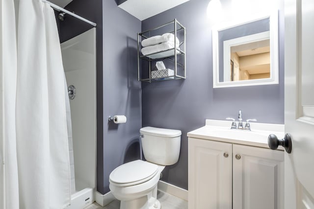 full bathroom with baseboards, toilet, a stall shower, and vanity