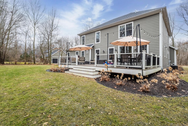 rear view of house with a lawn and a wooden deck