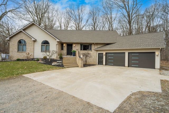 single story home with roof with shingles, an attached garage, brick siding, concrete driveway, and a front lawn
