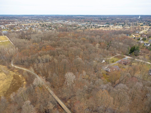 birds eye view of property with a view of trees