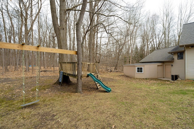 view of yard featuring a playground and central AC