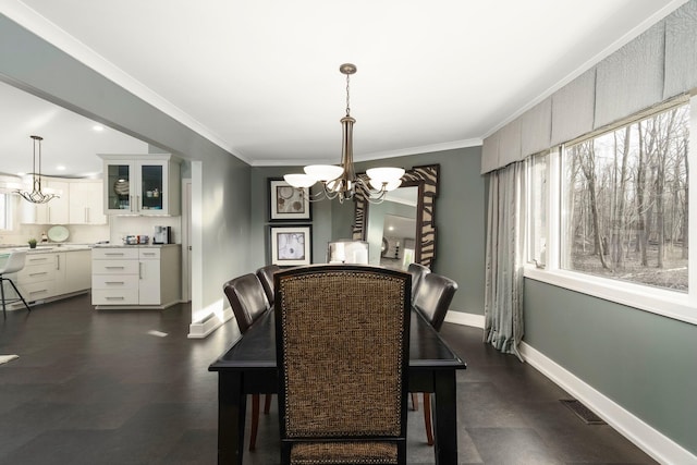 dining area featuring an inviting chandelier, visible vents, baseboards, and ornamental molding