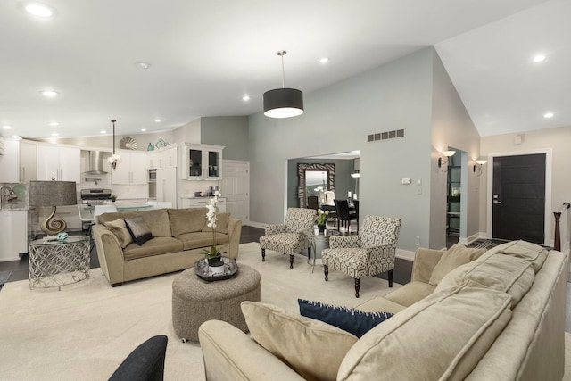 living area with baseboards, recessed lighting, and visible vents