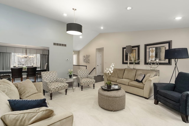 living room with lofted ceiling, light carpet, a notable chandelier, and visible vents