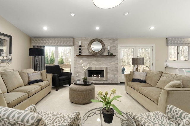 carpeted living area featuring recessed lighting and a large fireplace