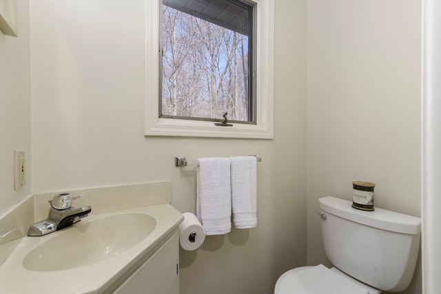 half bath featuring toilet and vanity