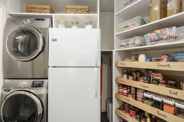 laundry room with stacked washing maching and dryer and laundry area