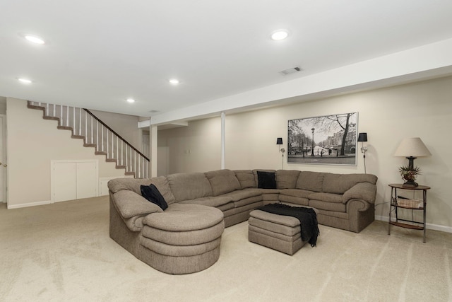 carpeted living area featuring stairway, baseboards, visible vents, and recessed lighting