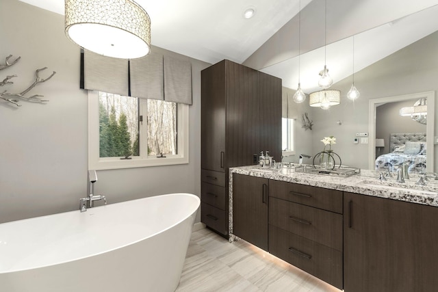 full bath featuring double vanity, a sink, a soaking tub, ensuite bath, and lofted ceiling