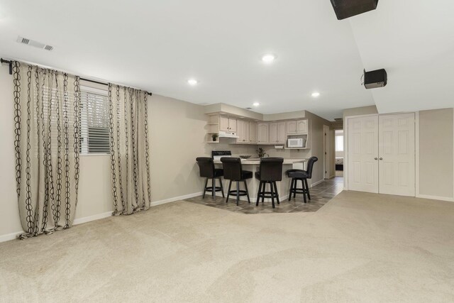 interior space featuring baseboards, light carpet, visible vents, and recessed lighting