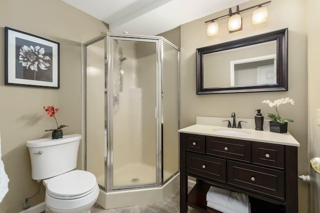 bathroom with vanity, toilet, and a shower stall