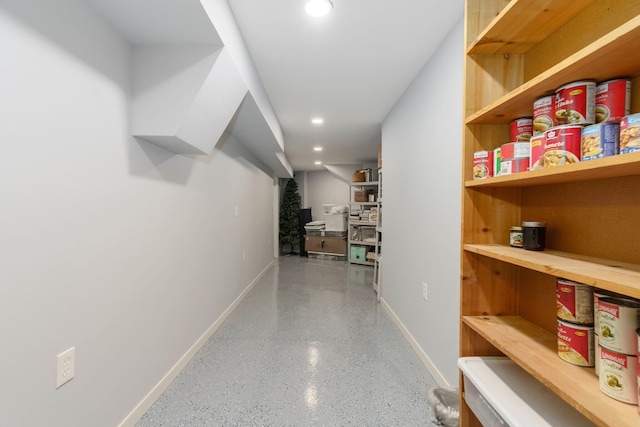 hall featuring baseboards and recessed lighting
