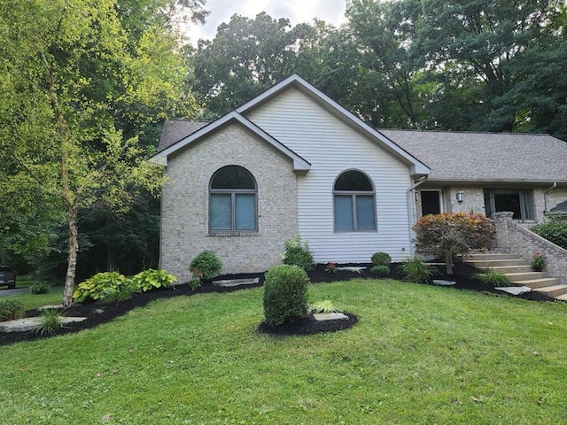 single story home with a front yard and brick siding