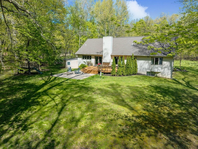 21395 Laser Ln, South Lyon, MI 48178 - back of property featuring a deck, a chimney, and a yard