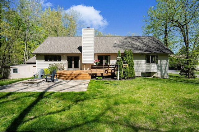 21395 Laser Ln, South Lyon, MI 48178 - back of property with french doors, an outdoor fire pit, a wooden deck, a lawn, and a chimney