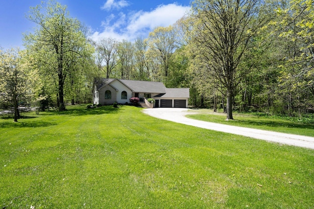 21395 Laser Ln, South Lyon, MI 48178 - view of front of house featuring a garage, a front yard, and driveway