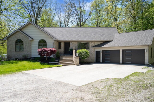 21395 Laser Ln, South Lyon, MI 48178 - view of front of property with driveway, an attached garage, a shingled roof, a front yard, and brick siding
