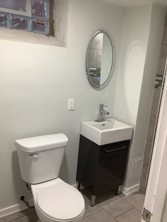 bathroom with tile patterned floors, toilet, vanity, and baseboards