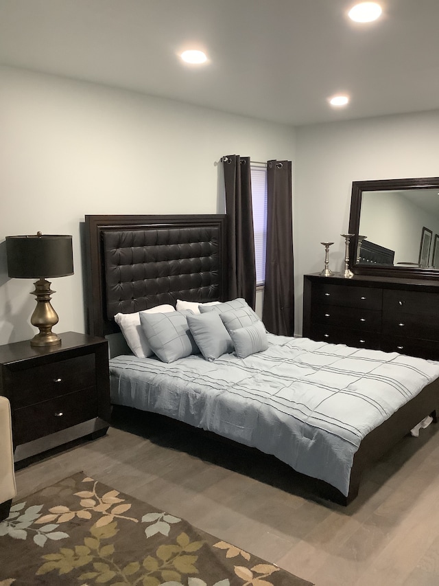 bedroom with wood finished floors and recessed lighting