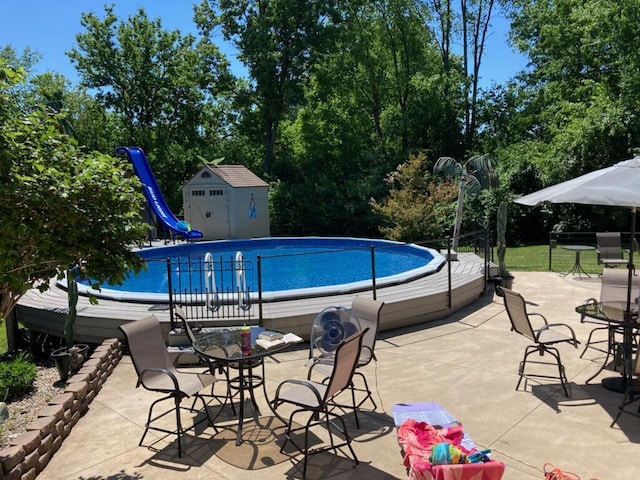 6501 Ackerson Lake Rd, Jackson, MI 49201 - pool with an outdoor structure, a storage unit, a patio area, and a water slide