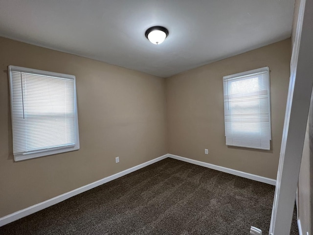 19980 Hickory St, Detroit, MI 48205 - spare room featuring dark colored carpet and baseboards
