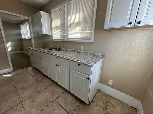 19980 Hickory St, Detroit, MI 48205 - kitchen featuring white cabinetry, light tile patterned floors, and light stone countertops