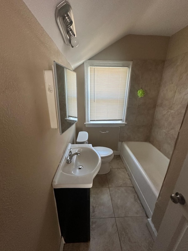 19980 Hickory St, Detroit, MI 48205 - bathroom featuring vaulted ceiling, tile patterned flooring, a tub to relax in, and vanity