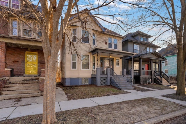 townhome / multi-family property featuring covered porch