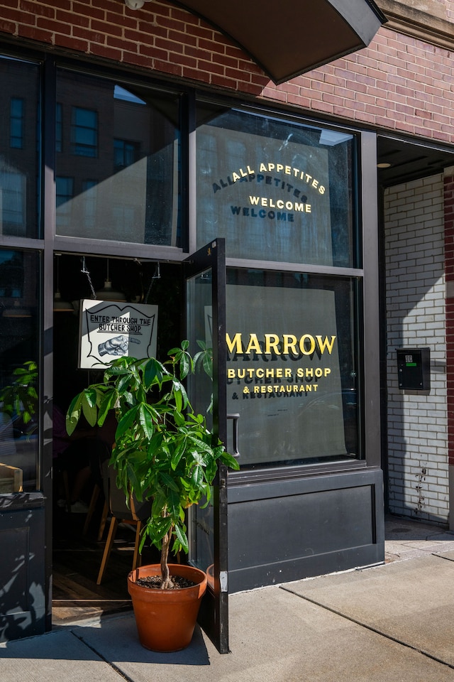 property entrance featuring brick siding