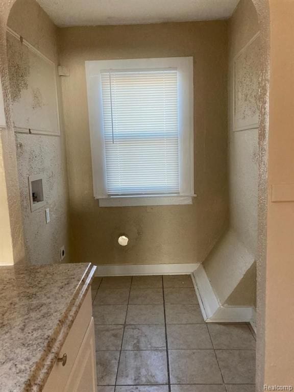 bathroom featuring tile patterned floors, baseboards, and vanity