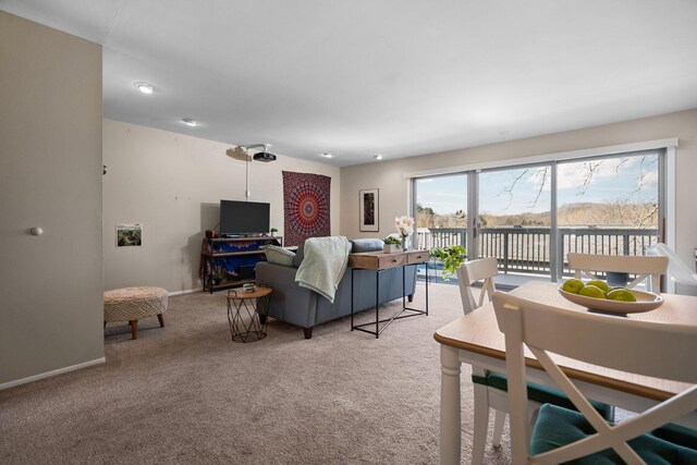 carpeted living room featuring baseboards