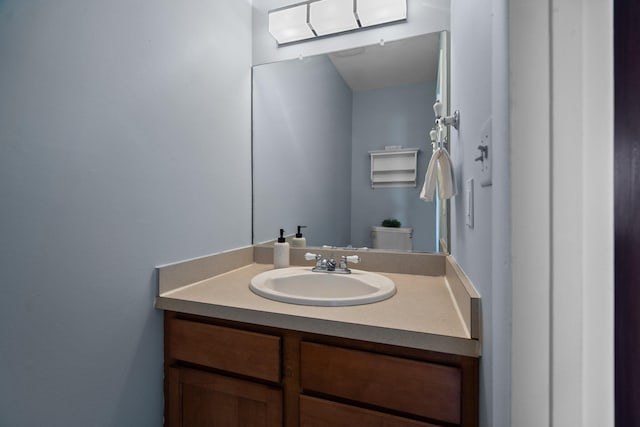 half bath featuring toilet and vanity