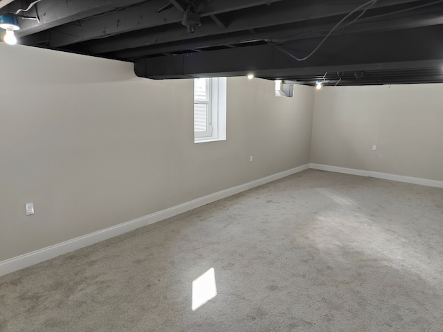 basement featuring carpet floors and baseboards