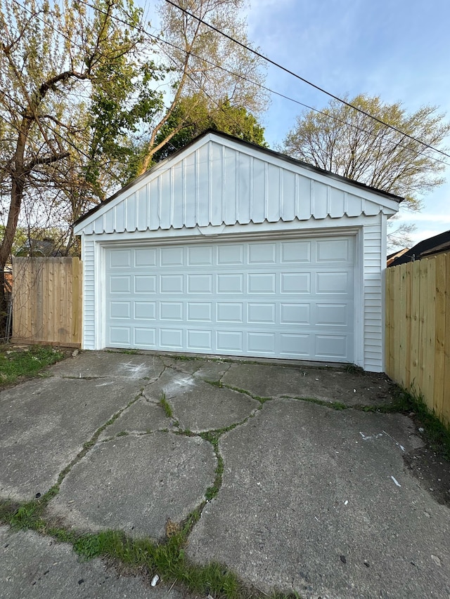 detached garage featuring fence