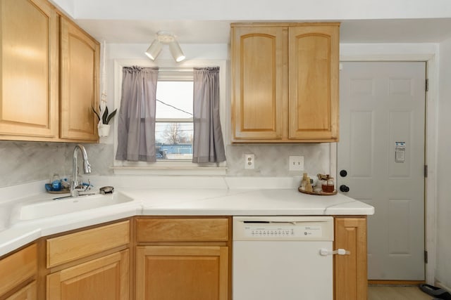 kitchen with light brown cabinetry, white dishwasher, a sink, and light countertops