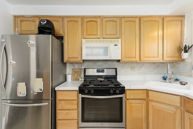 kitchen with light countertops, appliances with stainless steel finishes, and light brown cabinets