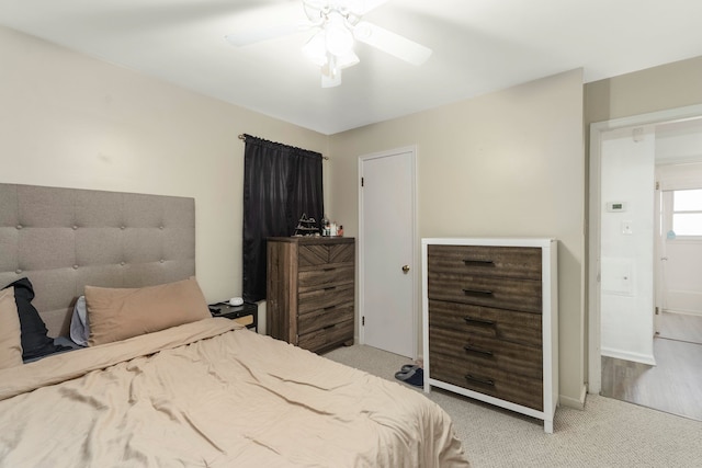 bedroom with a ceiling fan and light colored carpet