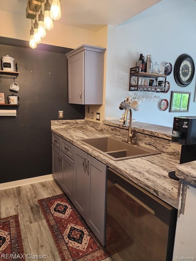 37512 Jefferson Ave Unit # 301, Harrison Township, MI 48045 - kitchen with dishwasher, a sink, gray cabinets, light wood finished floors, and light stone counters