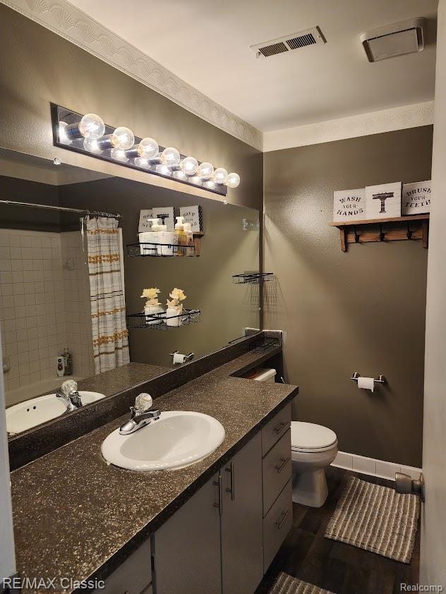 37512 Jefferson Ave Unit # 301, Harrison Township, MI 48045 - bathroom featuring toilet, vanity, a shower with shower curtain, and baseboards