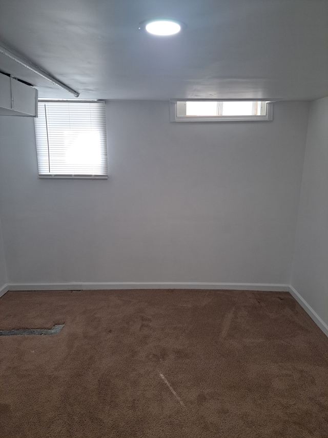 below grade area featuring baseboards and carpet floors