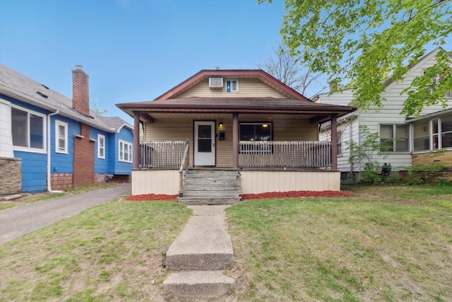 bungalow featuring a porch and a front yard
