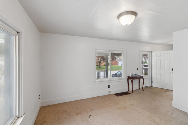 unfurnished room with baseboards and carpet flooring