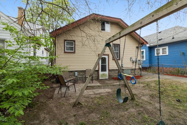 back of property with a patio and fence