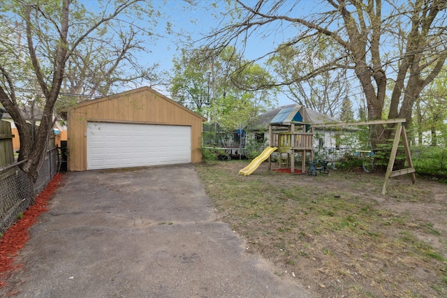 detached garage featuring fence