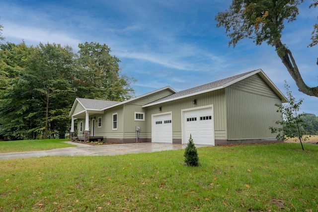 view of front facade featuring an attached garage, concrete driveway, and a front yard