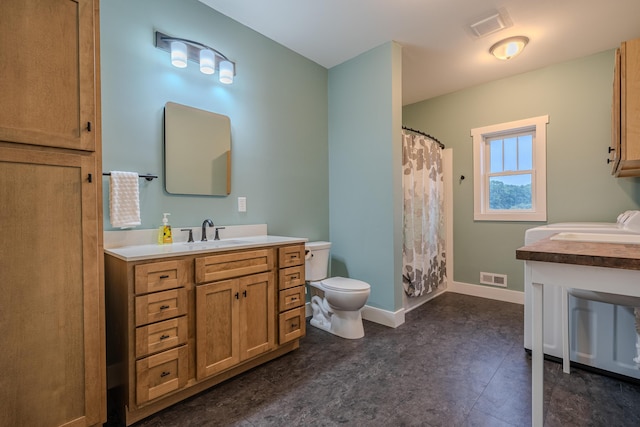 bathroom featuring visible vents, toilet, vanity, and baseboards
