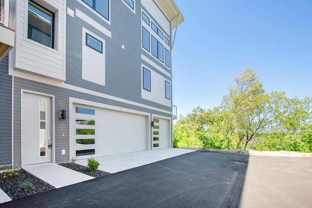 631 Fairview Ave NE Unit 3, Grand Rapids, MI 49503 - view of home's exterior with a garage and aphalt driveway