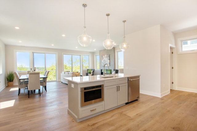 631 Fairview Ave NE Unit 3, Grand Rapids, MI 49503 - kitchen with light wood-style flooring, recessed lighting, a sink, light countertops, and appliances with stainless steel finishes