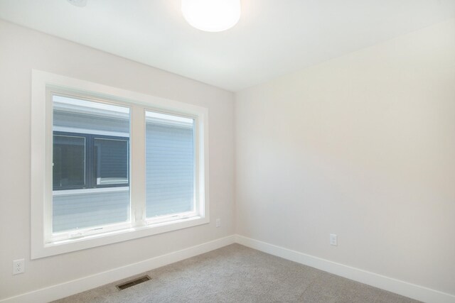 631 Fairview Ave NE Unit 3, Grand Rapids, MI 49503 - spare room with carpet flooring, baseboards, and visible vents